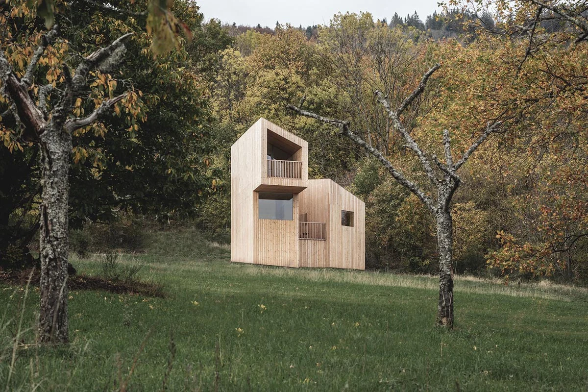 Cabin on stilts clad in untreated local chestnut