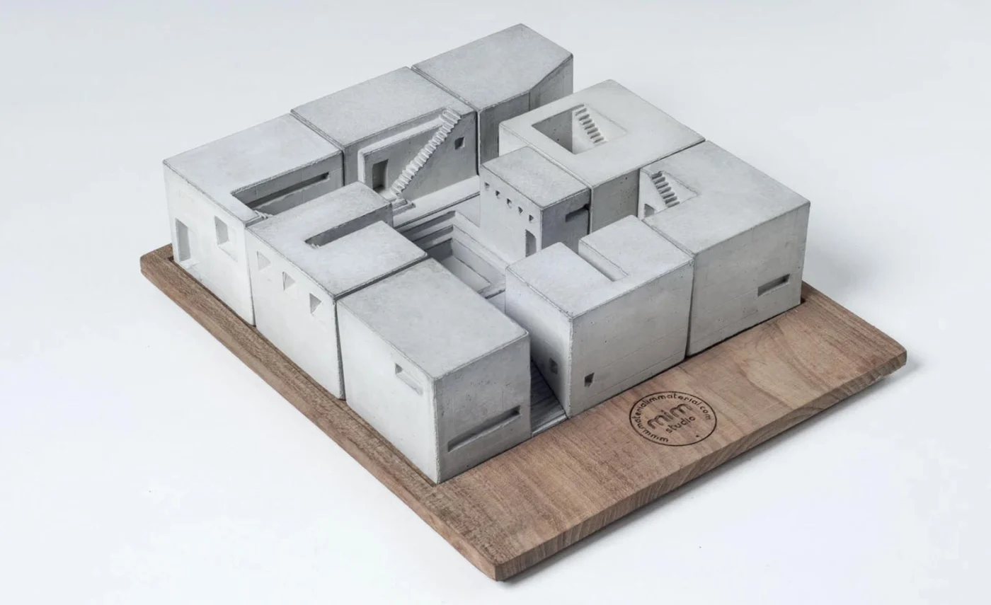 Nine small concrete house sculptures