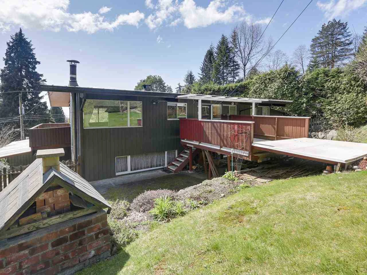 The rear of the house before the remodel, with a dated deck