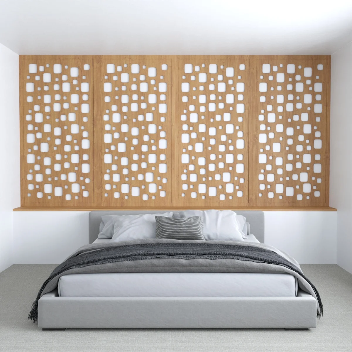 Wood panels with cut-out shapes forming a screen in front of the wall