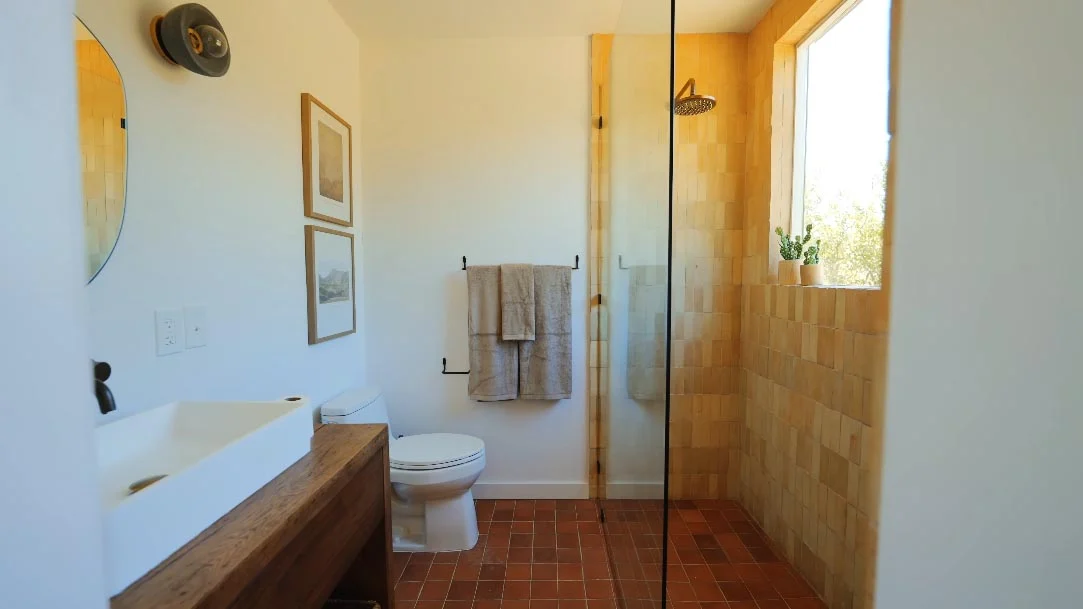 Small bathroom with a tiled walk-in shower and a window