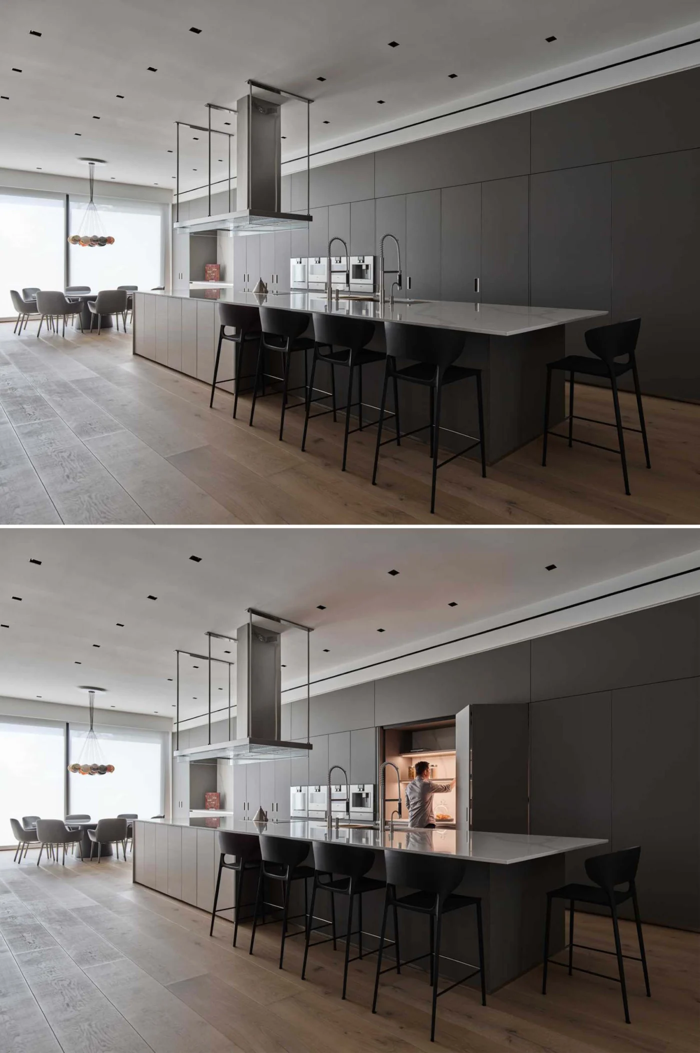 Kitchen with a long island and grey cabinets against stained wood floors