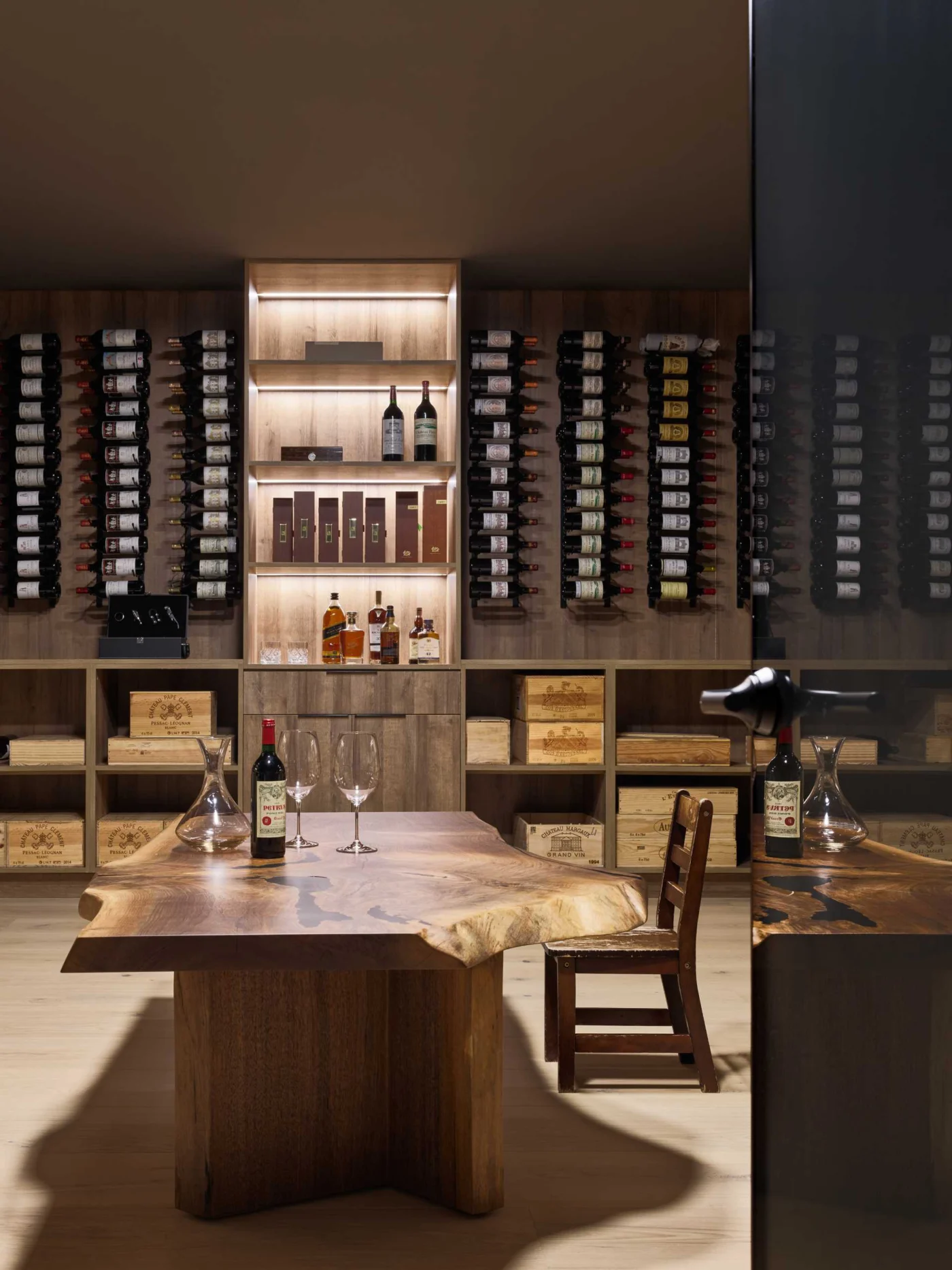 Wine cellar with wall-mounted racks, open storage and a live edge table