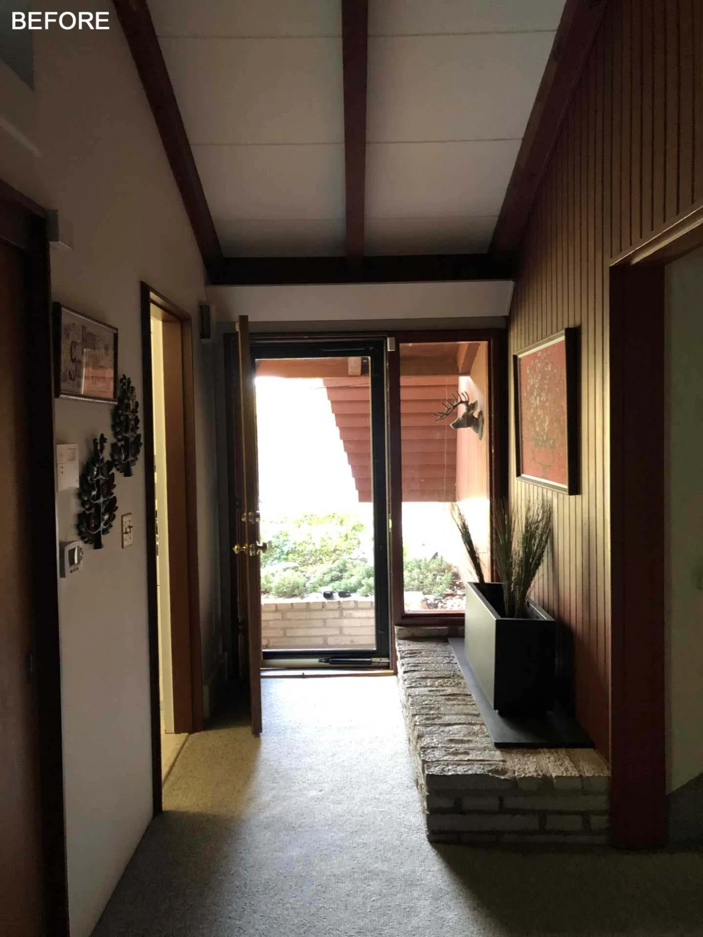 Original dark entryway lit only by a window beside the front door