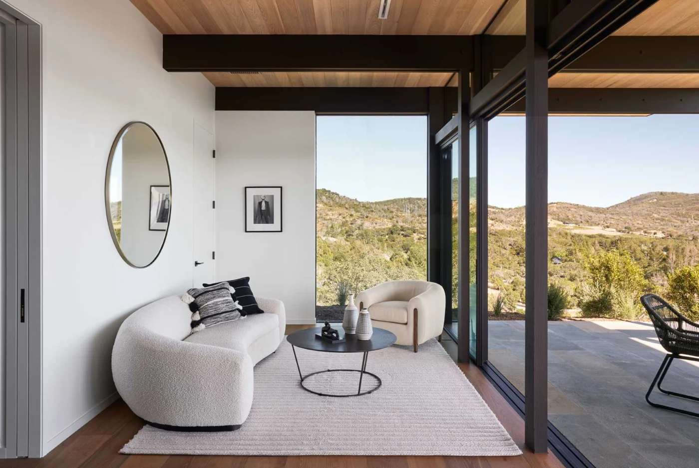 Relaxed living room with a curved boucle sofa and sliding glass doors to a patio