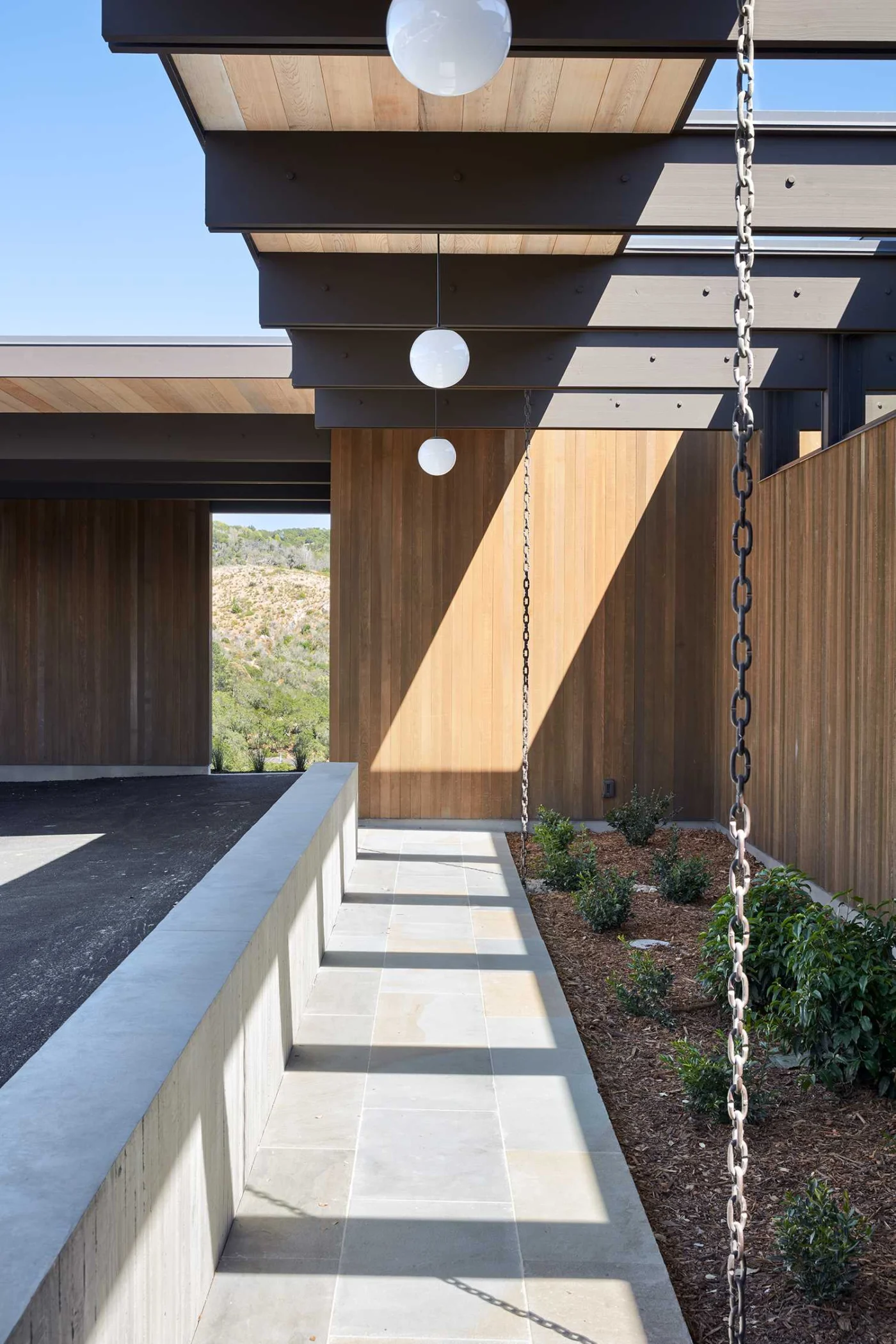 Rain chain guiding water from the roof into the garden