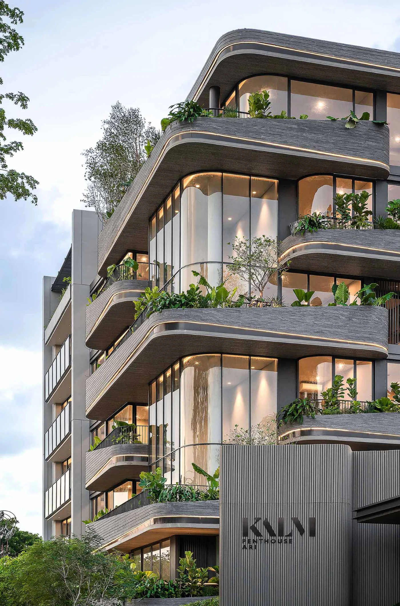 Thin lines of light set into the curved balconies of the facade