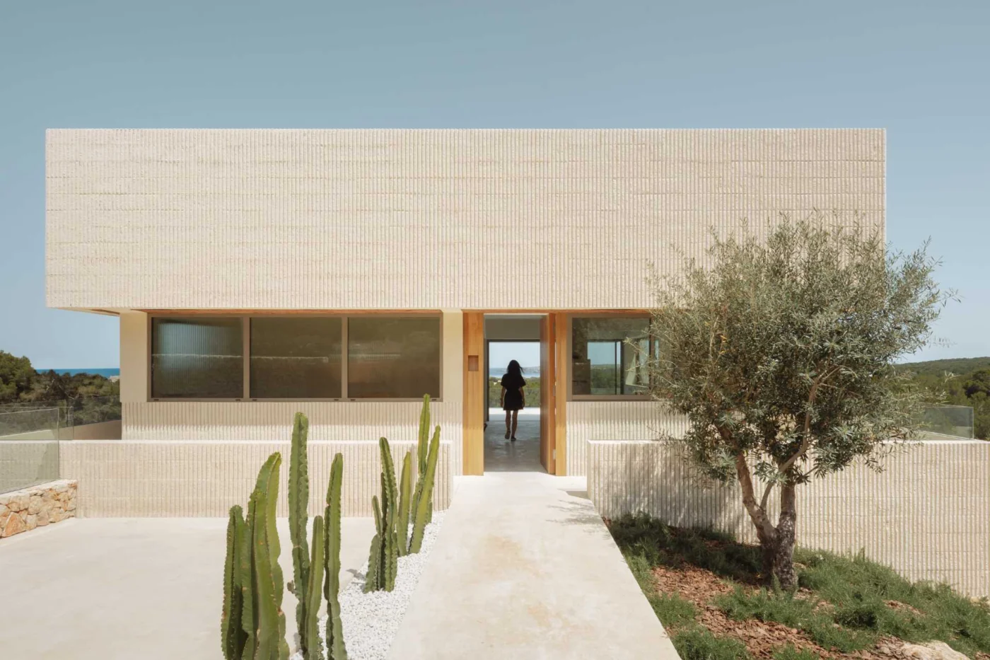 Fluted Concrete Walls Cut by Continuous Window Openings Define This Villa