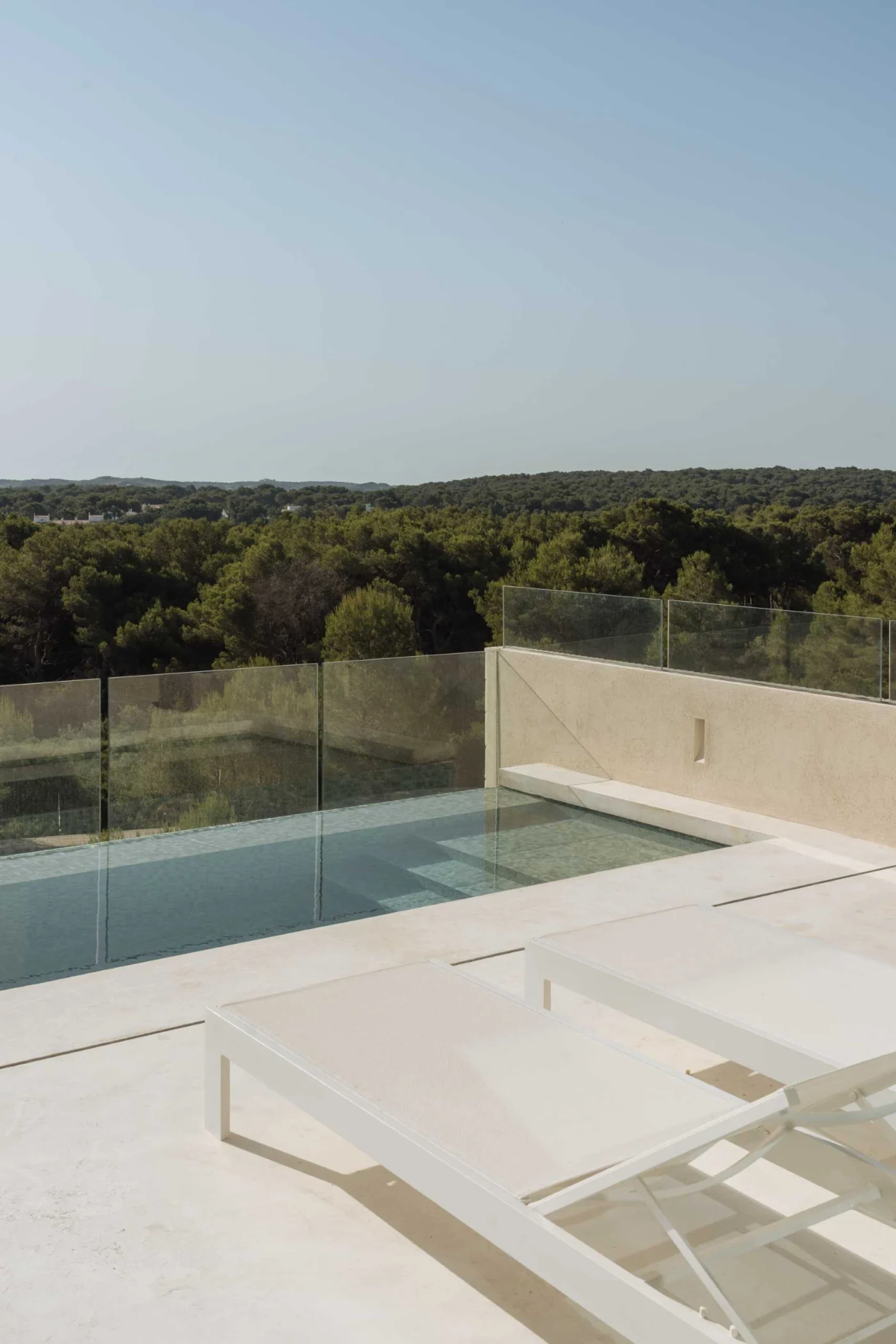 Elevated terrace extending into a spill-over pool with sea views