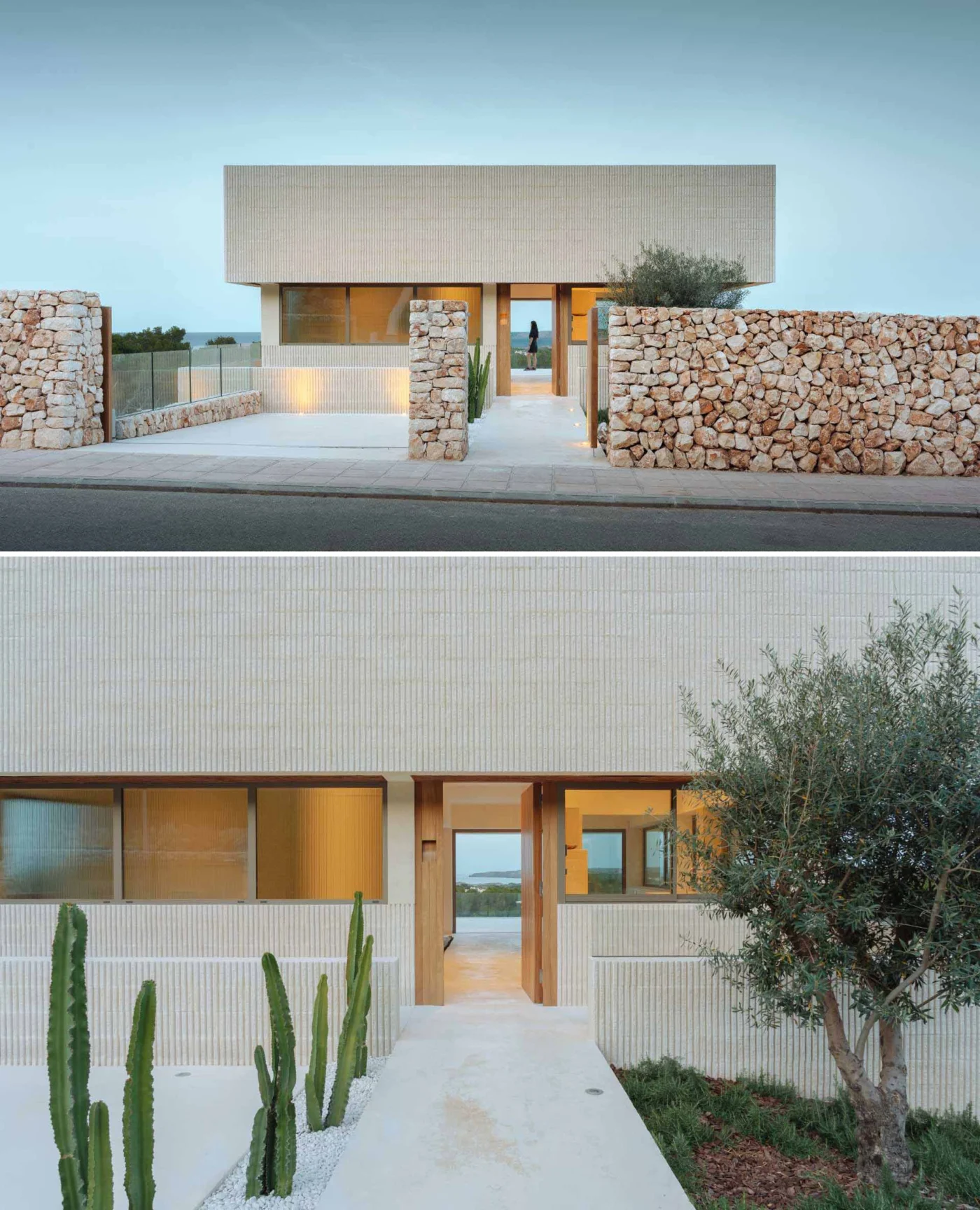 Stone wall at the front of the villa with plants and lights leading to the door