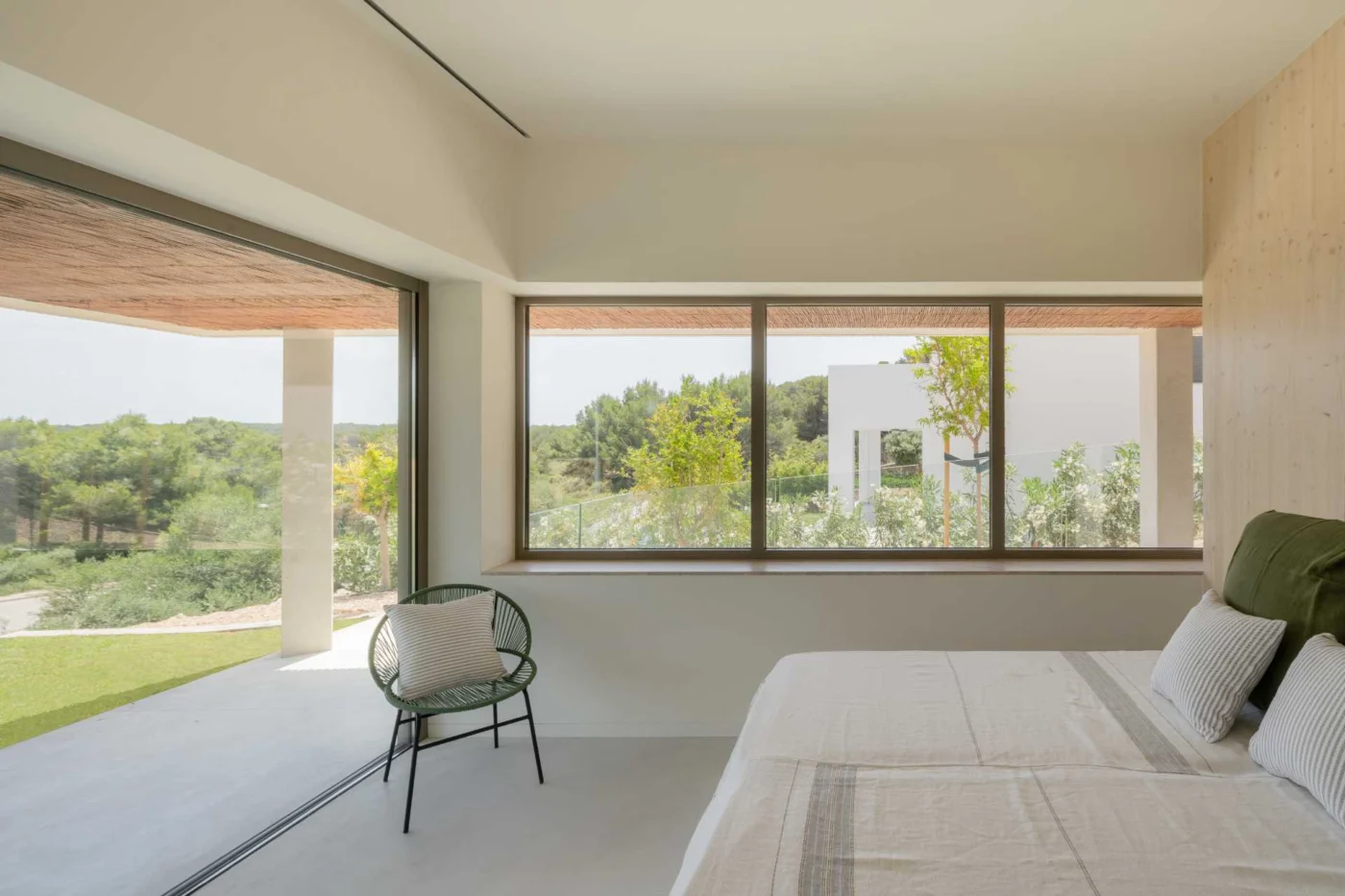 Bedroom with a sliding door onto a shaded terrace