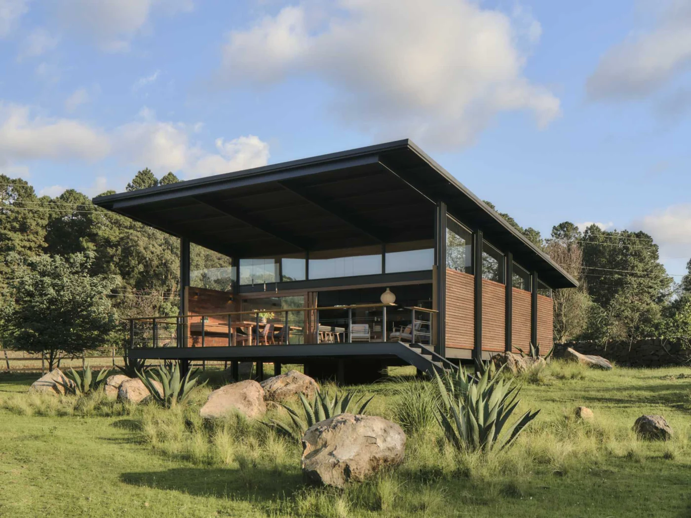 A Single Sloping Roof Covers This Home That Hovers Above the Land