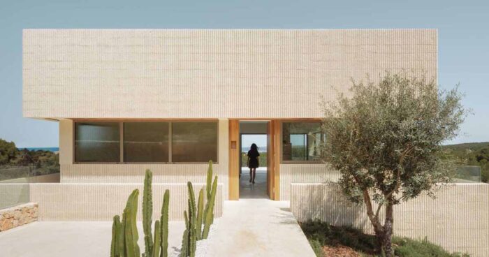 fluted-concrete-walls-cut-by-continuous-window-openings-define-this-villa