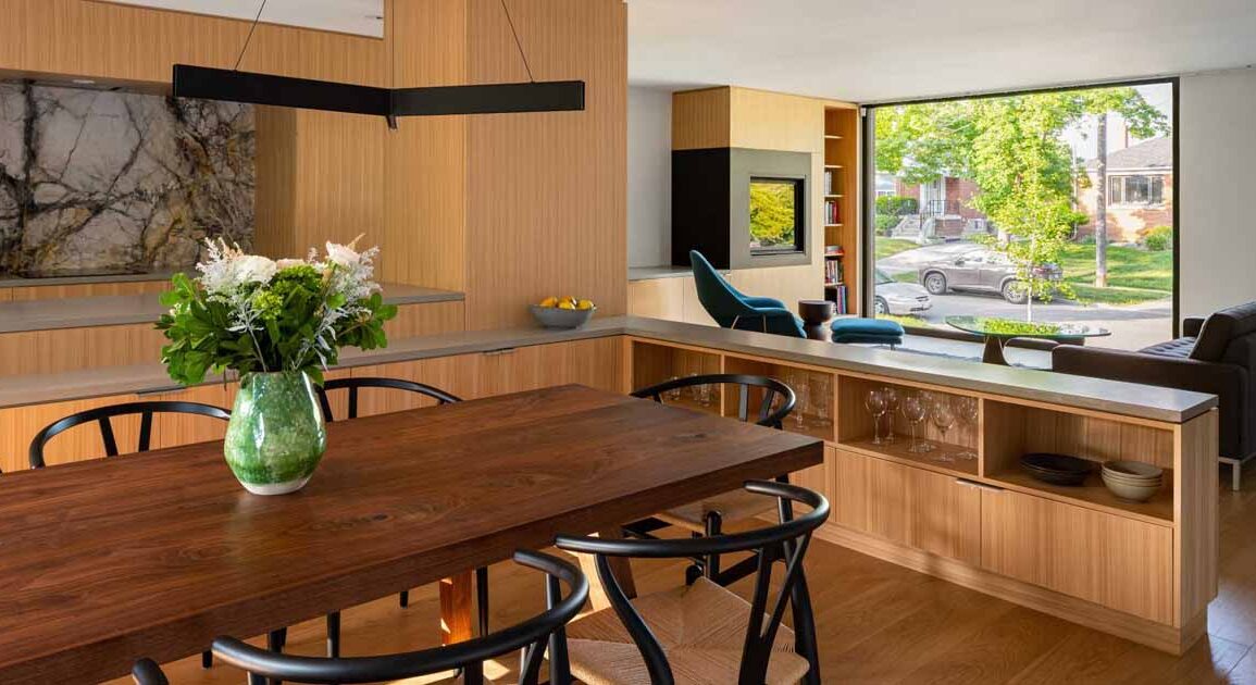 a-distinct-dining-area-was-created-in-this-home-by-surrounding-it-with-cabinetry