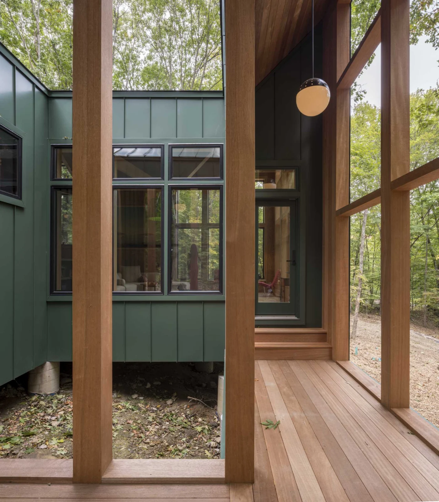 Covered porch with wood posts and a view into the courtyard