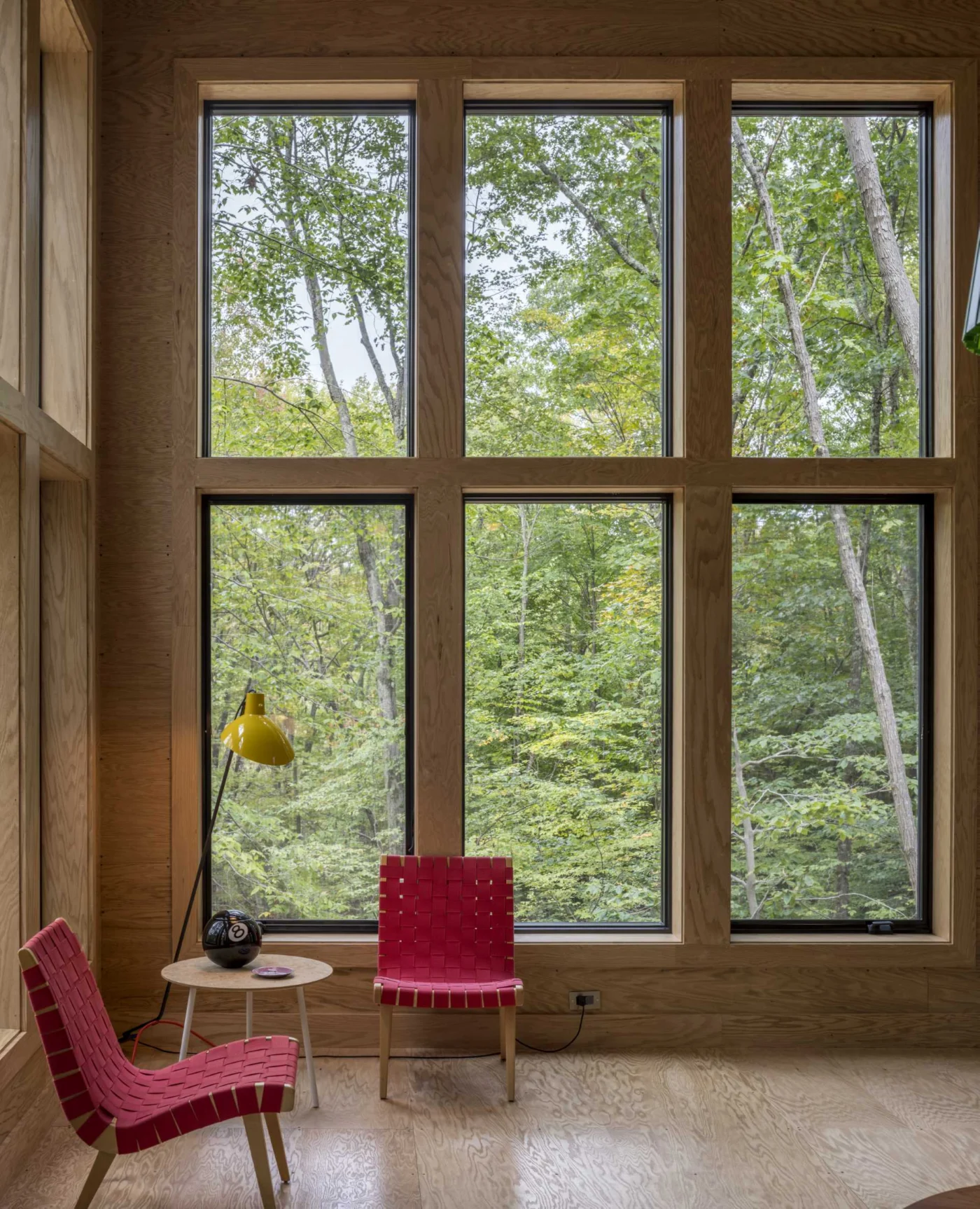 Tall windows in the living room framing the trees