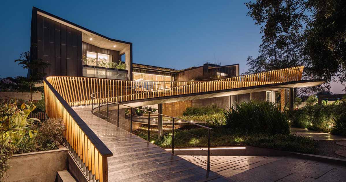 a-curving-bridge-leads-to-the-entertainment-areas-of-this-modern-home