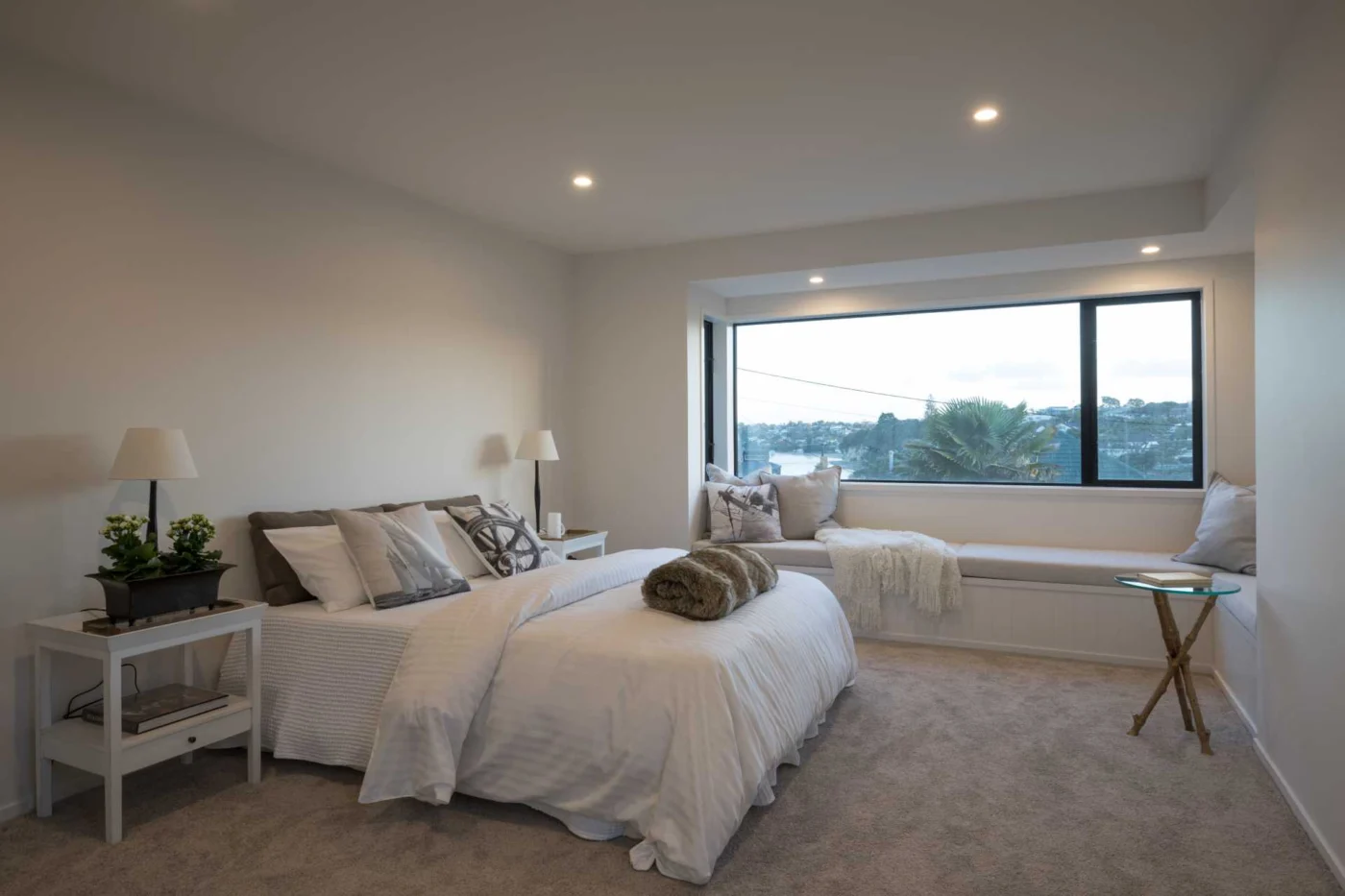 Bedroom with an L-shaped window seat looking out to the view
