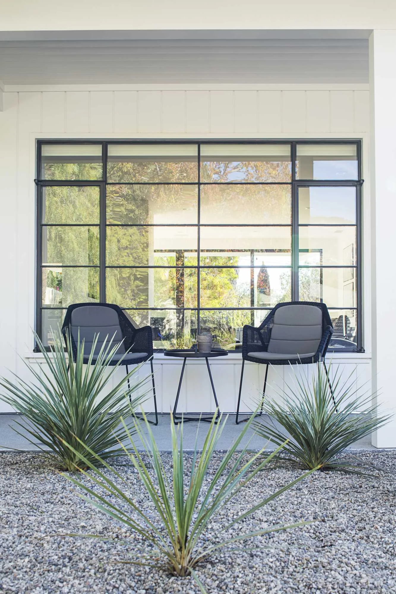 Front porch framed by native succulents, olive trees and grasses