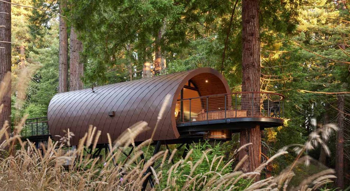 a-tube-shaped-treehouse-wrapped-in-diamond-shaped-metal-tiles