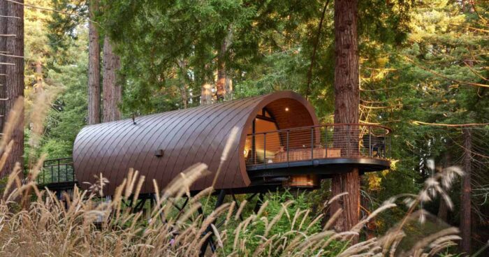 a-tube-shaped-treehouse-wrapped-in-diamond-shaped-metal-tiles