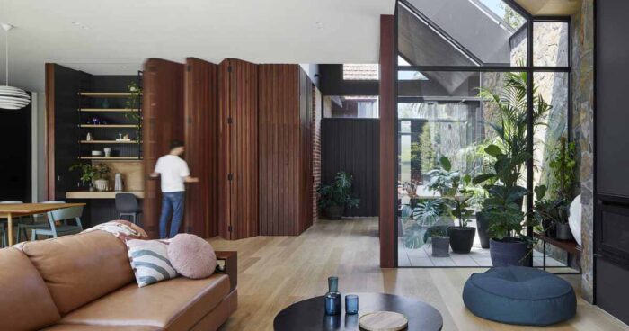 a-home-office-was-hidden-behind-a-wall-that-folds-open