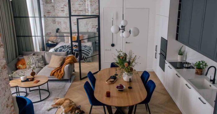 a-glass-wall-separates-a-bedroom-from-the-living-spaces-in-this-apartment