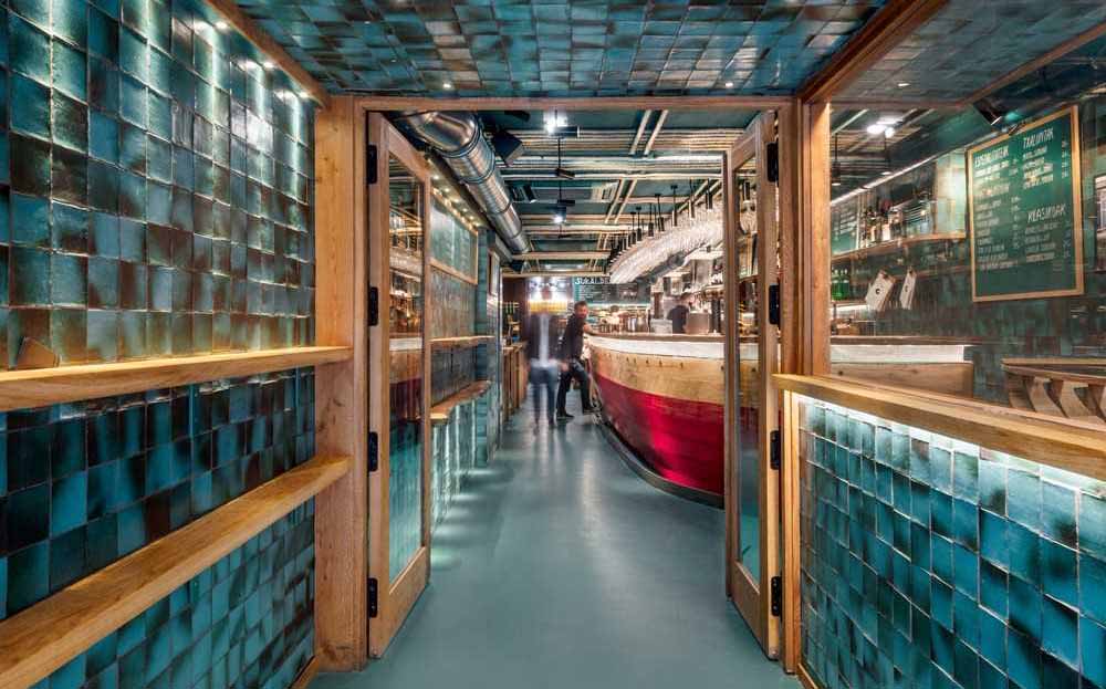 handmade-turquoise-tiles-line-the-entrance-to-this-spanish-restaurant