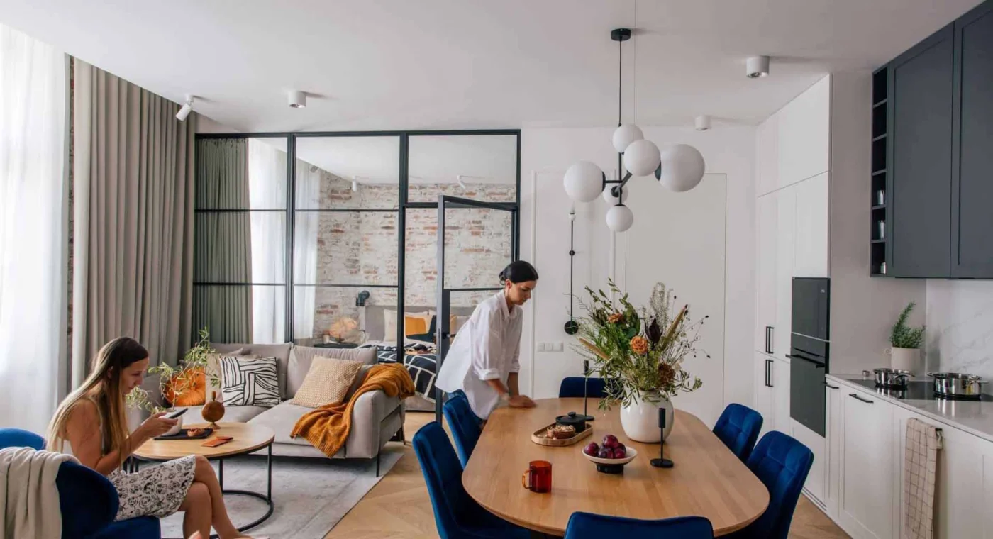 Black-framed glass wall letting daylight pass from the bedroom into the living space