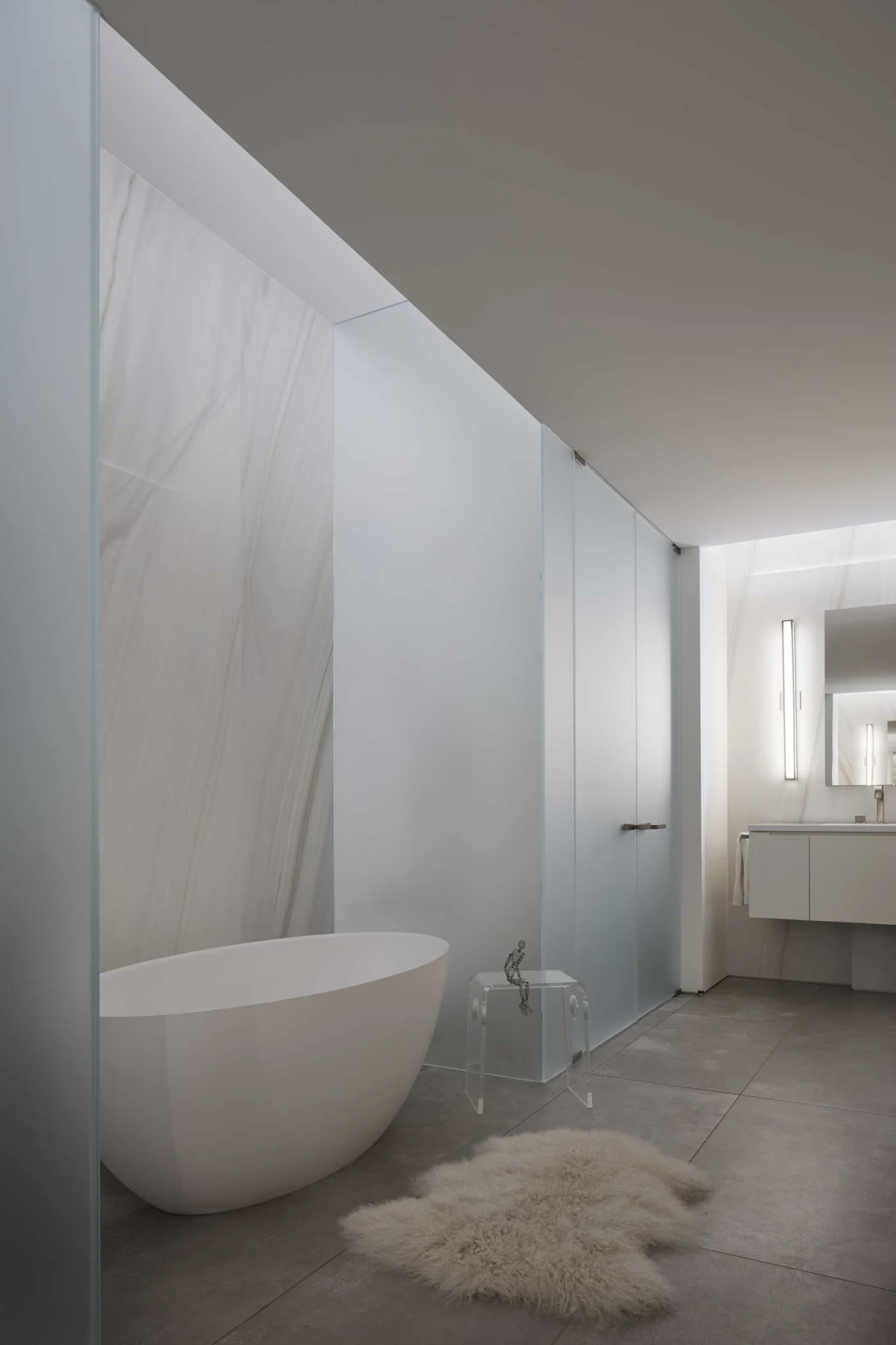 Bathroom with a freestanding bathtub and frosted glass walls