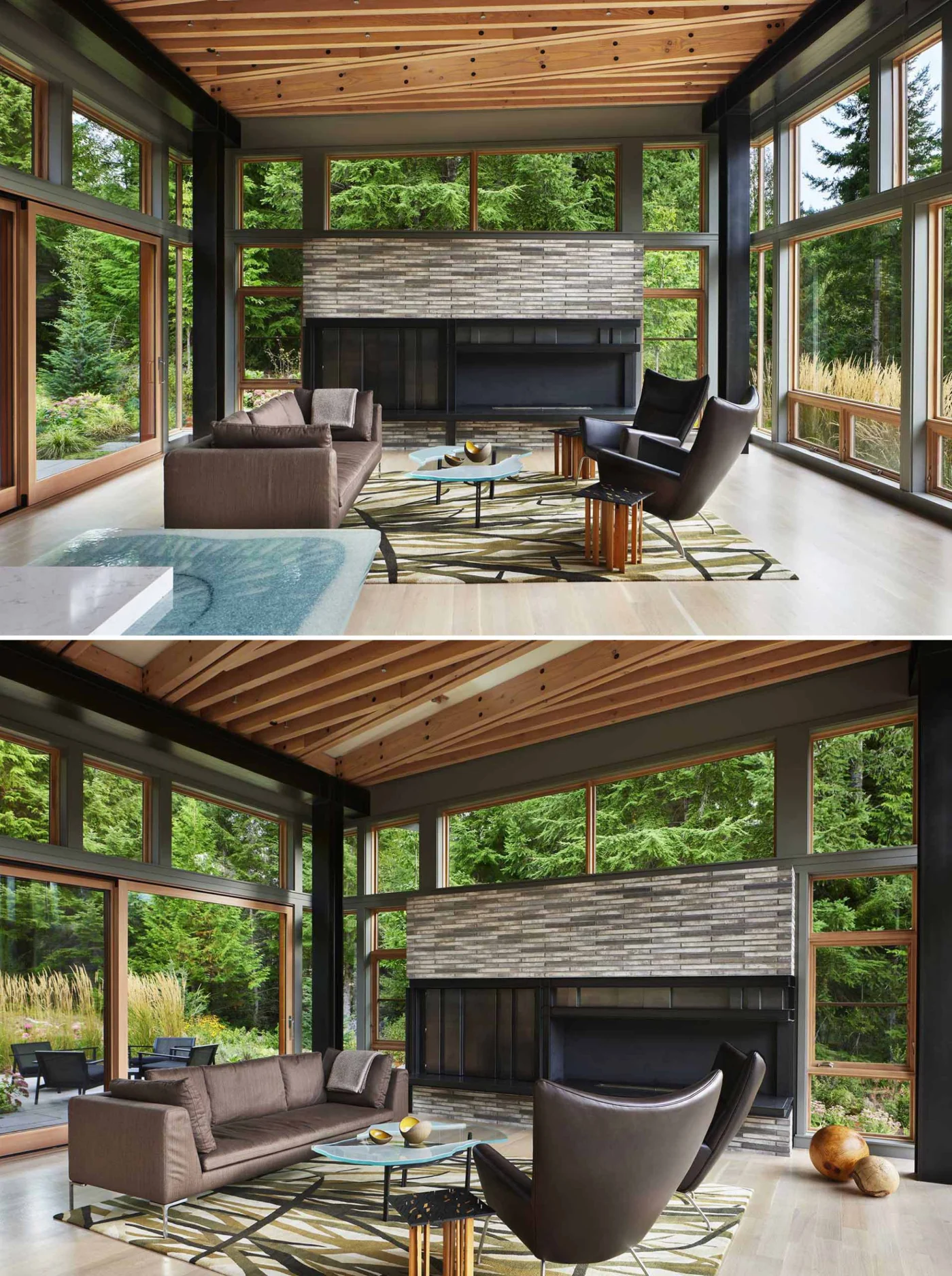 Living area with glass walls and a fireplace in grey brick