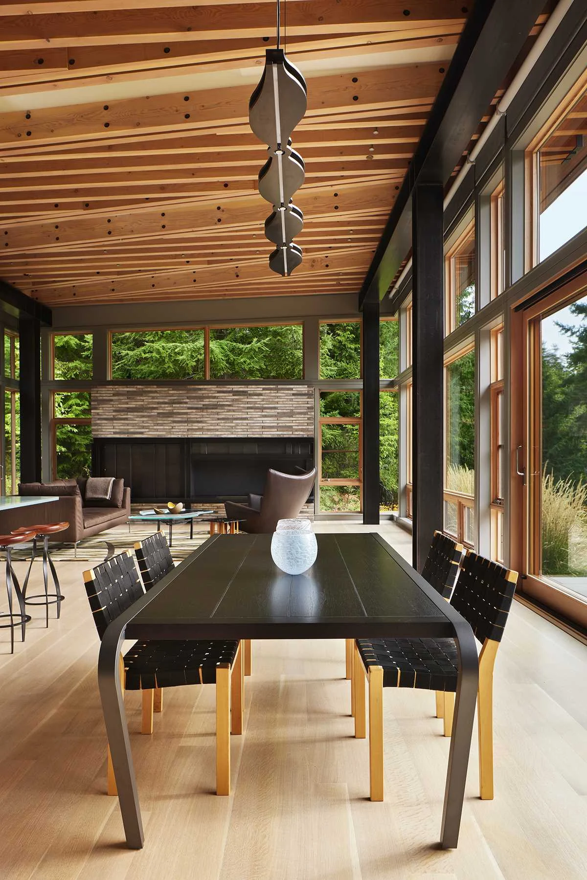 Dining table beneath custom pendant lights and the wood ceiling