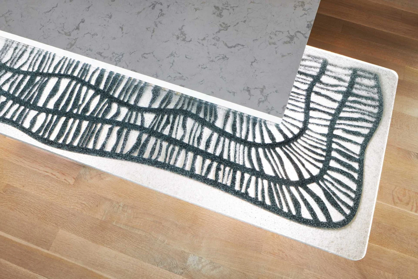 Laser-cut steel panel supporting the cast-glass breakfast counter