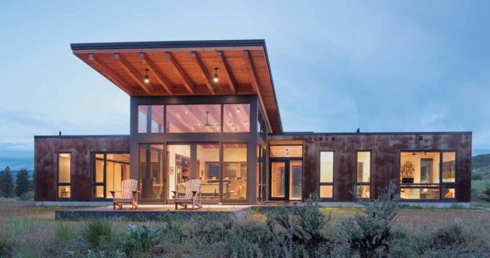 a-dramatic-upward-sloping-roof-covers-this-rural-home