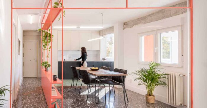 a-brightly-coloured-shelving-unit-helps-to-define-areas-in-this-renovated-apartment