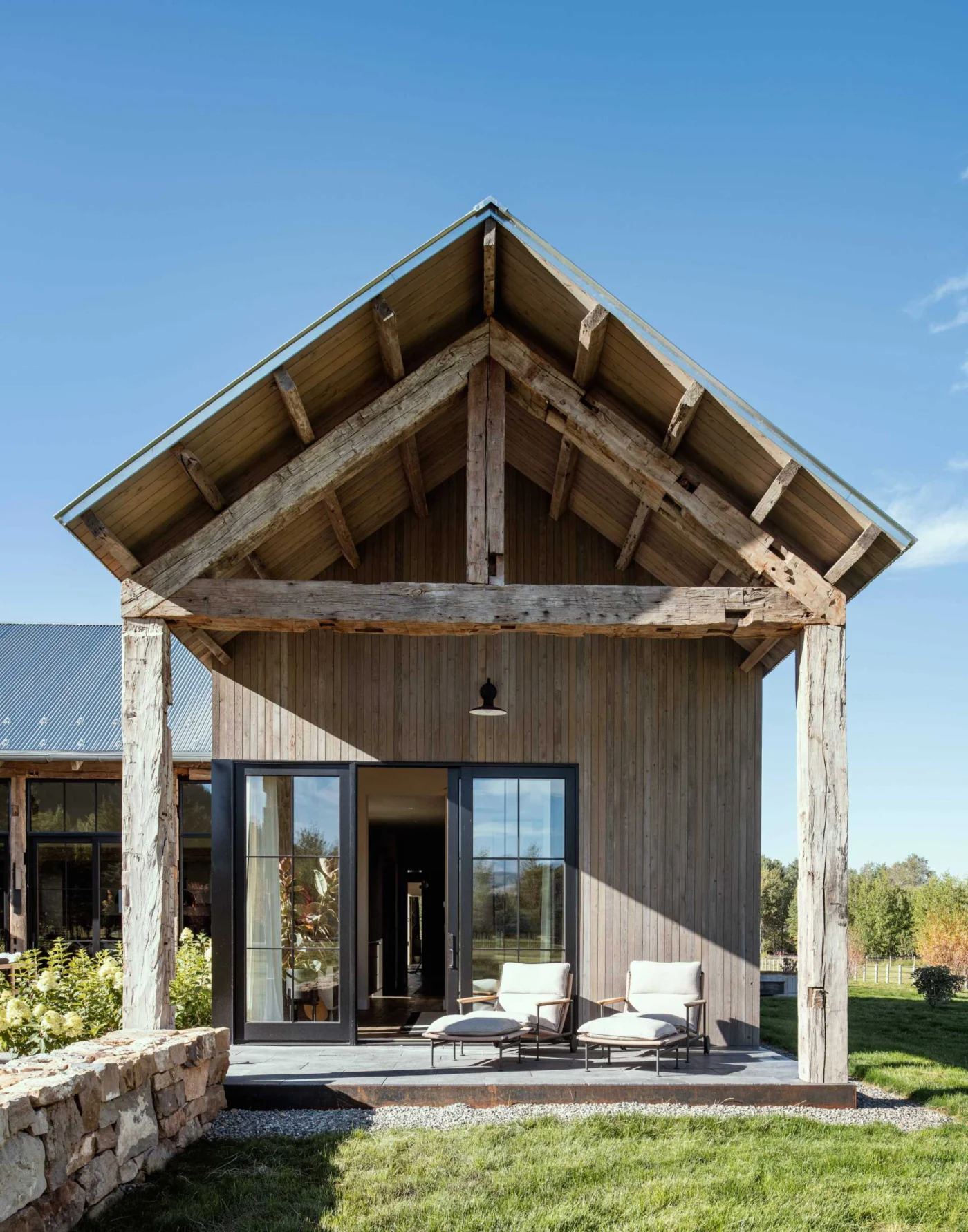 Outdoor patio framed by rustic hand-hewn timbers