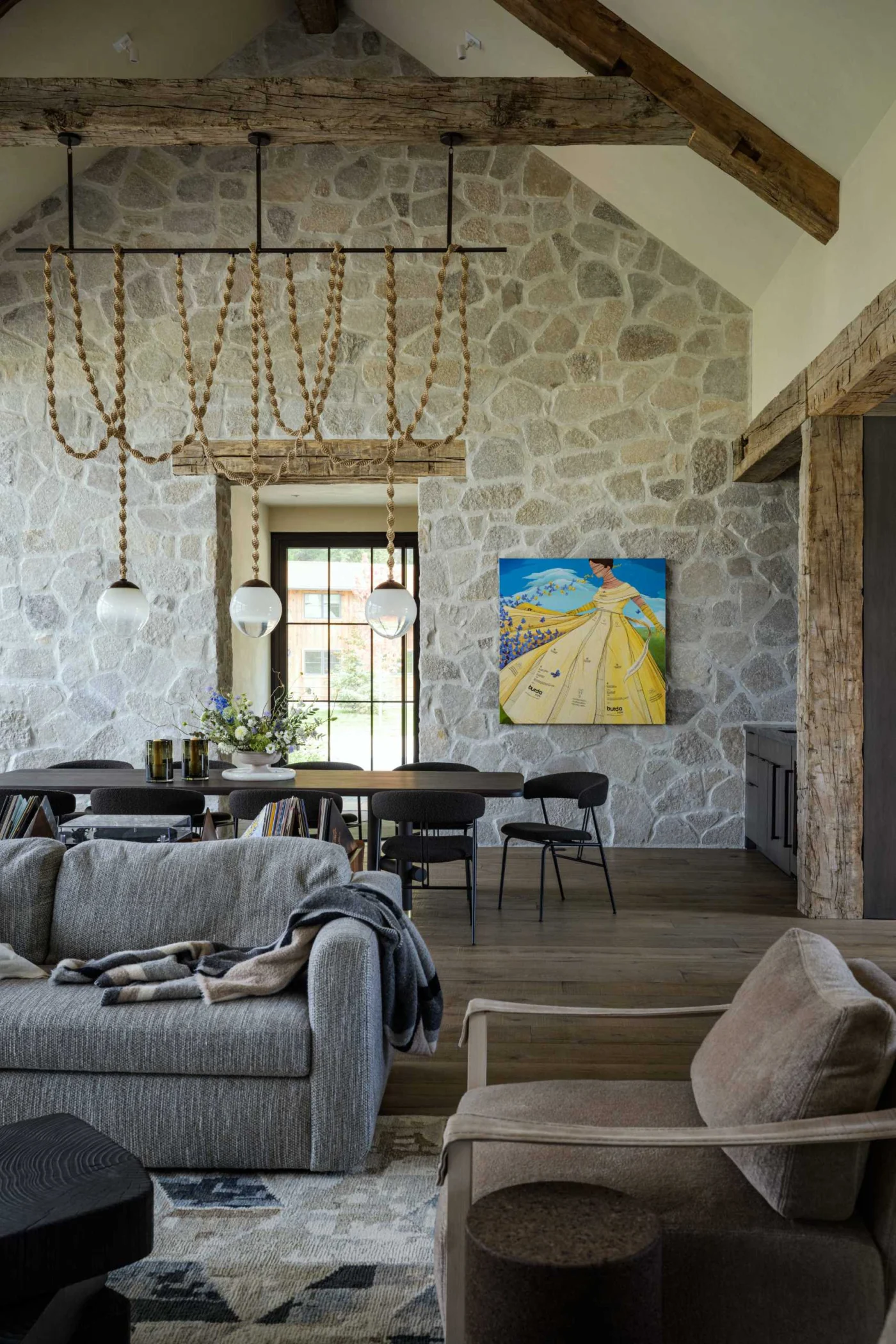 Floor-to-ceiling stone wall in the living and dining area