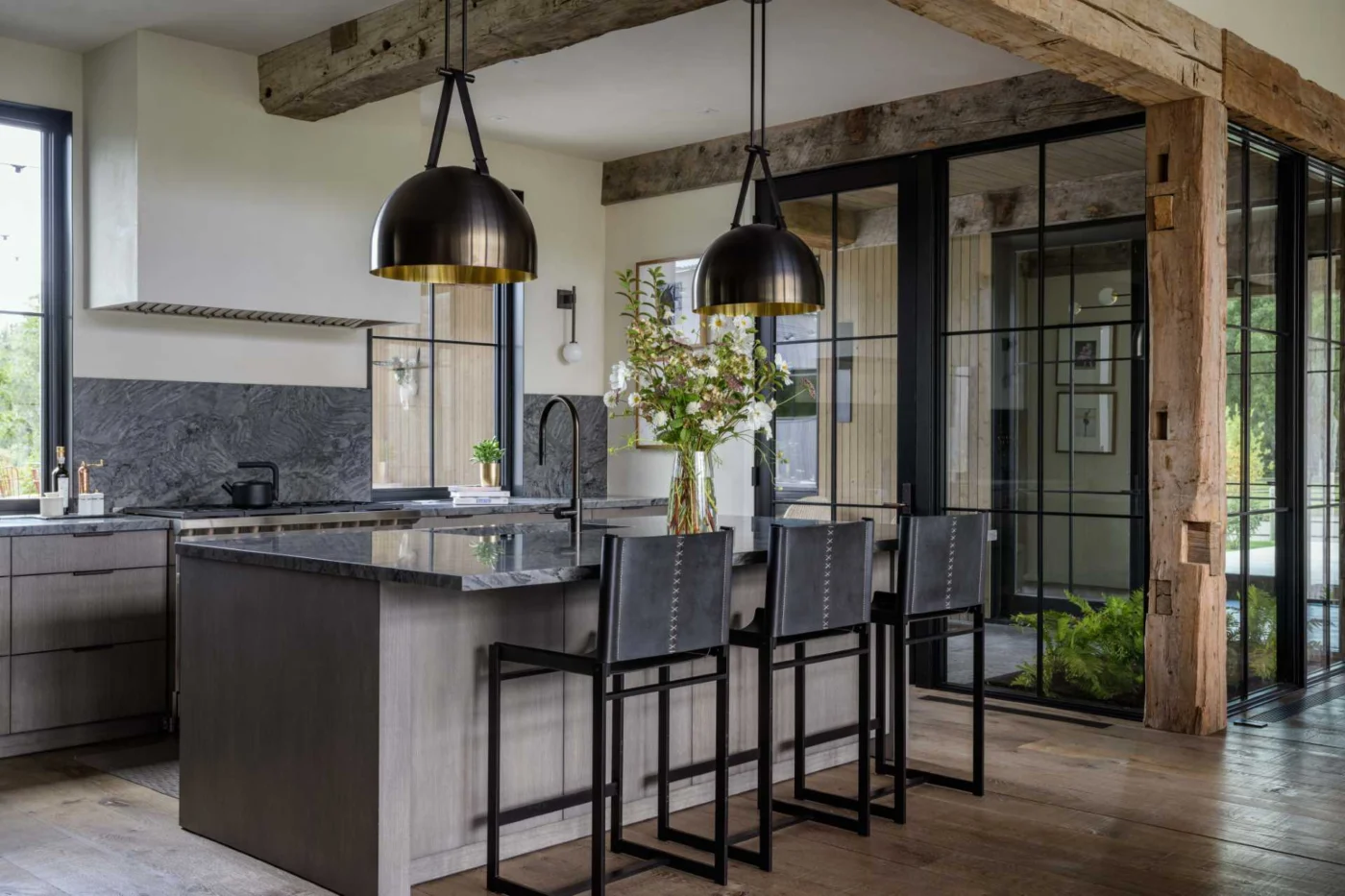 Custom kitchen with dark countertops and finishes mixing modern and rustic