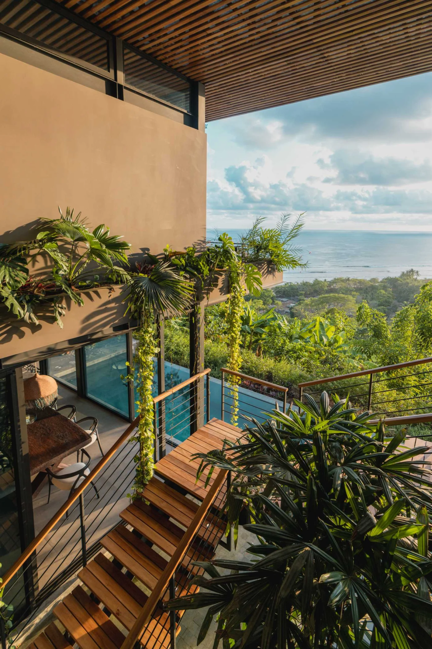 Open staircase in the central atrium above a shallow extension of the pool