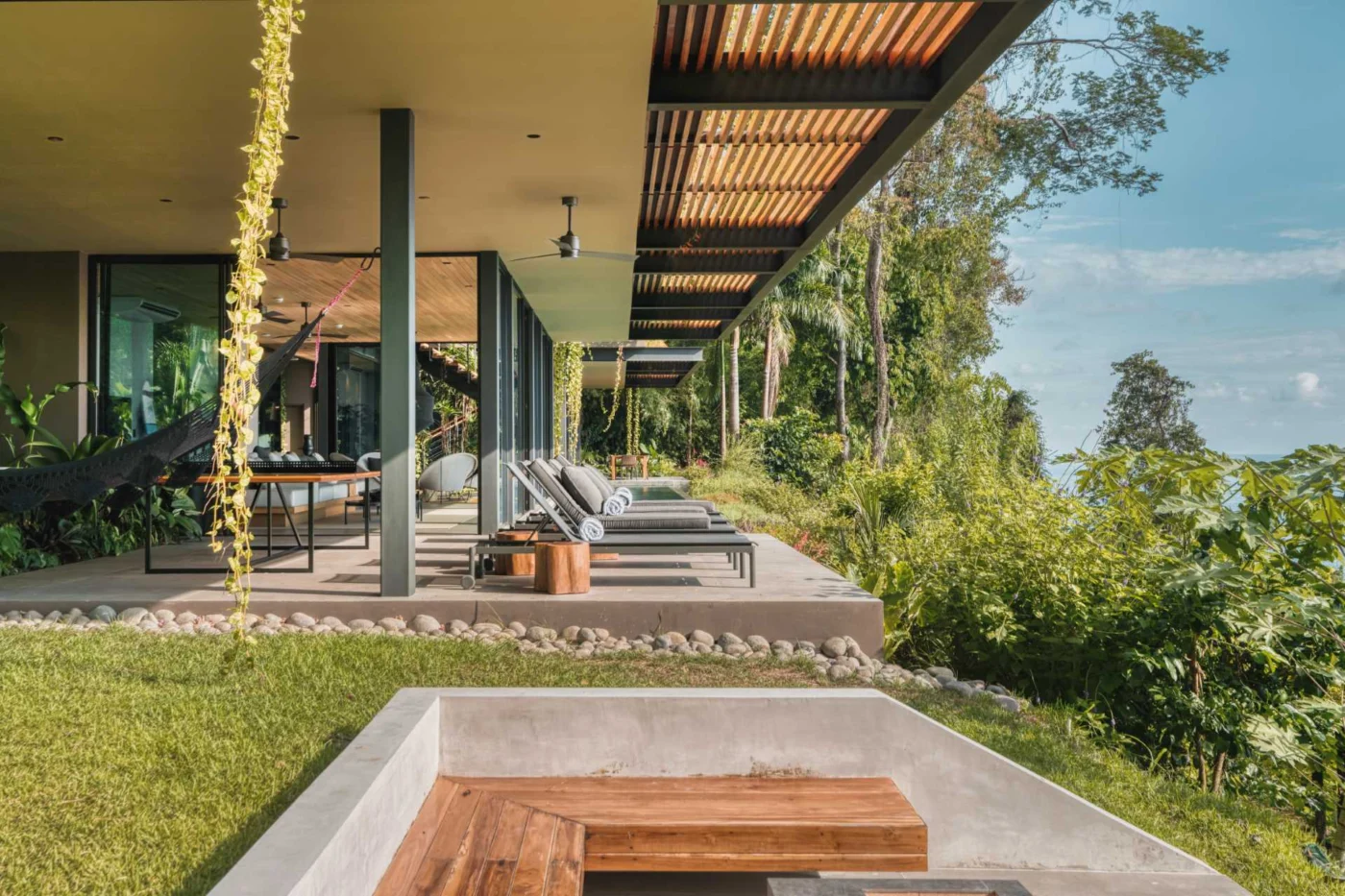 Outdoor area with sun loungers at one end of the pool