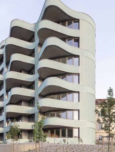 undulating-balconies-and-a-mint-green-tiled-exterior-give-this-new-building-a-unique-look