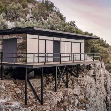 a-modern-cabin-perched-on-the-edge-of-rocky-cliffs