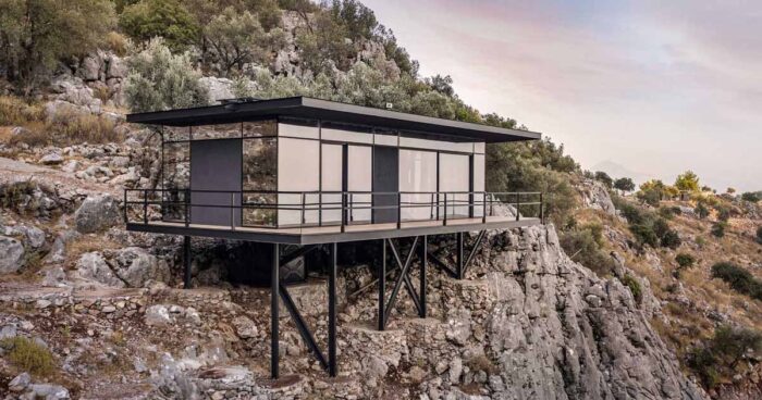 a-modern-cabin-perched-on-the-edge-of-rocky-cliffs