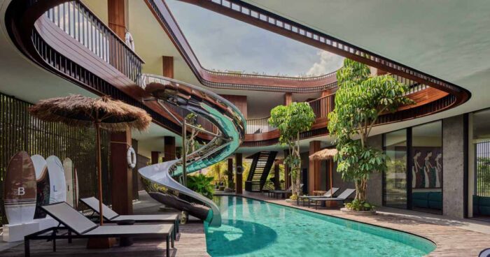 this-home-was-designed-to-surround-a-swimming-pool-with-a-slide