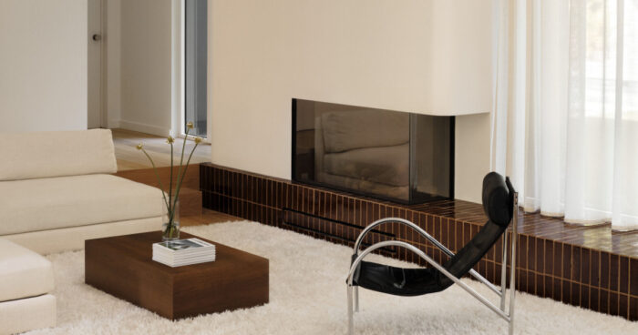 at-first-it-looks-simple,-then-you-notice-the-curved-fireplace-and-built-in-lounge