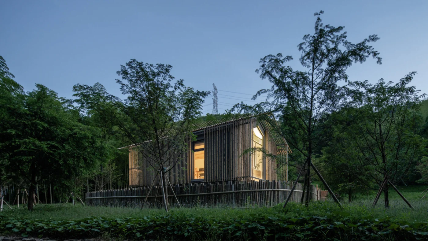 Bamboo screen facade filtering sunlight around a minimalist hotel room