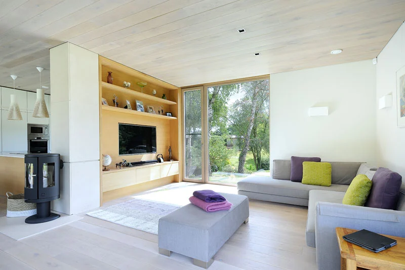 Living room with built-in cabinetry and a wood stove