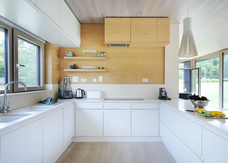 U-shaped kitchen with white and wood cabinets and open shelving