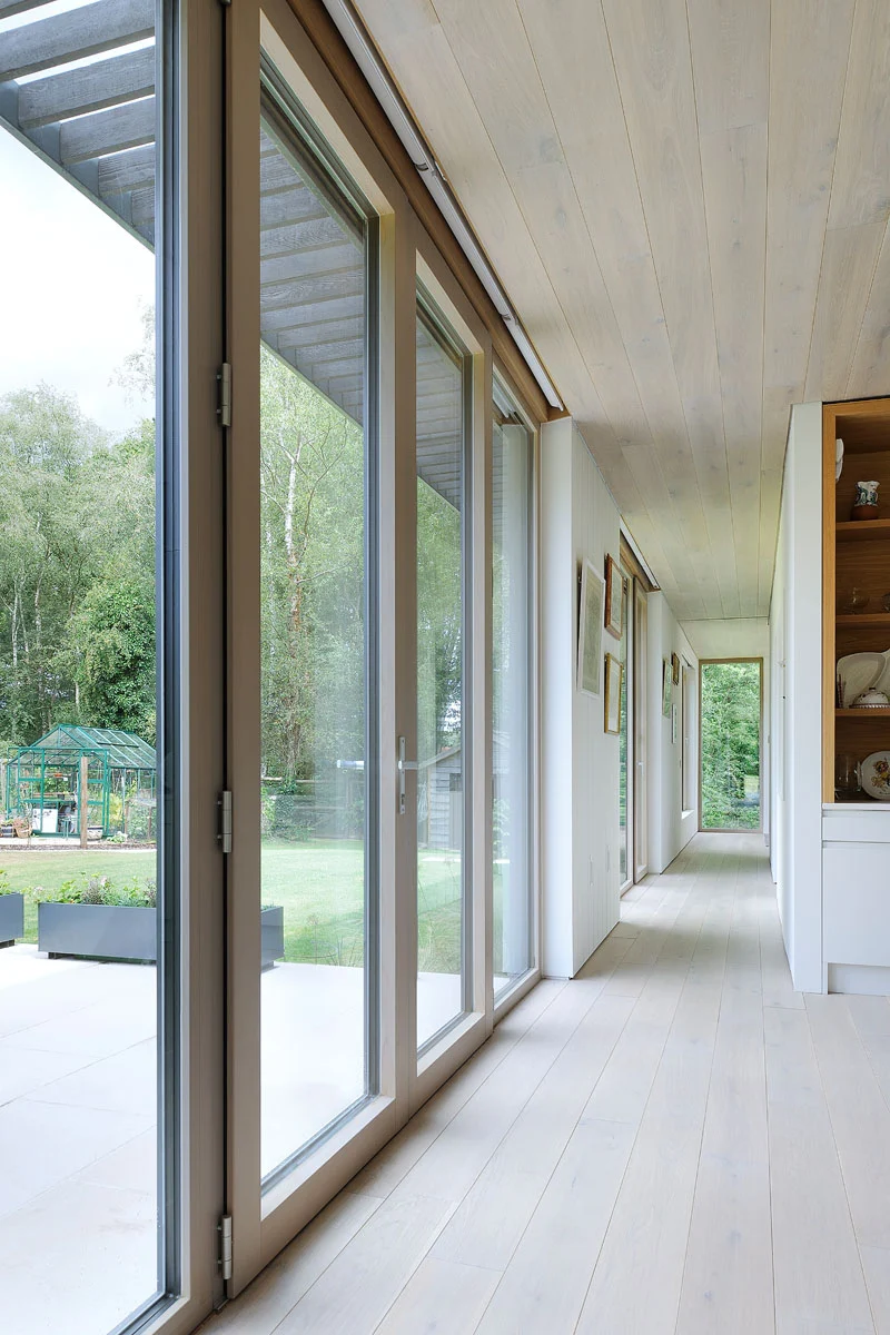 Hallway lined with floor-to-ceiling windows