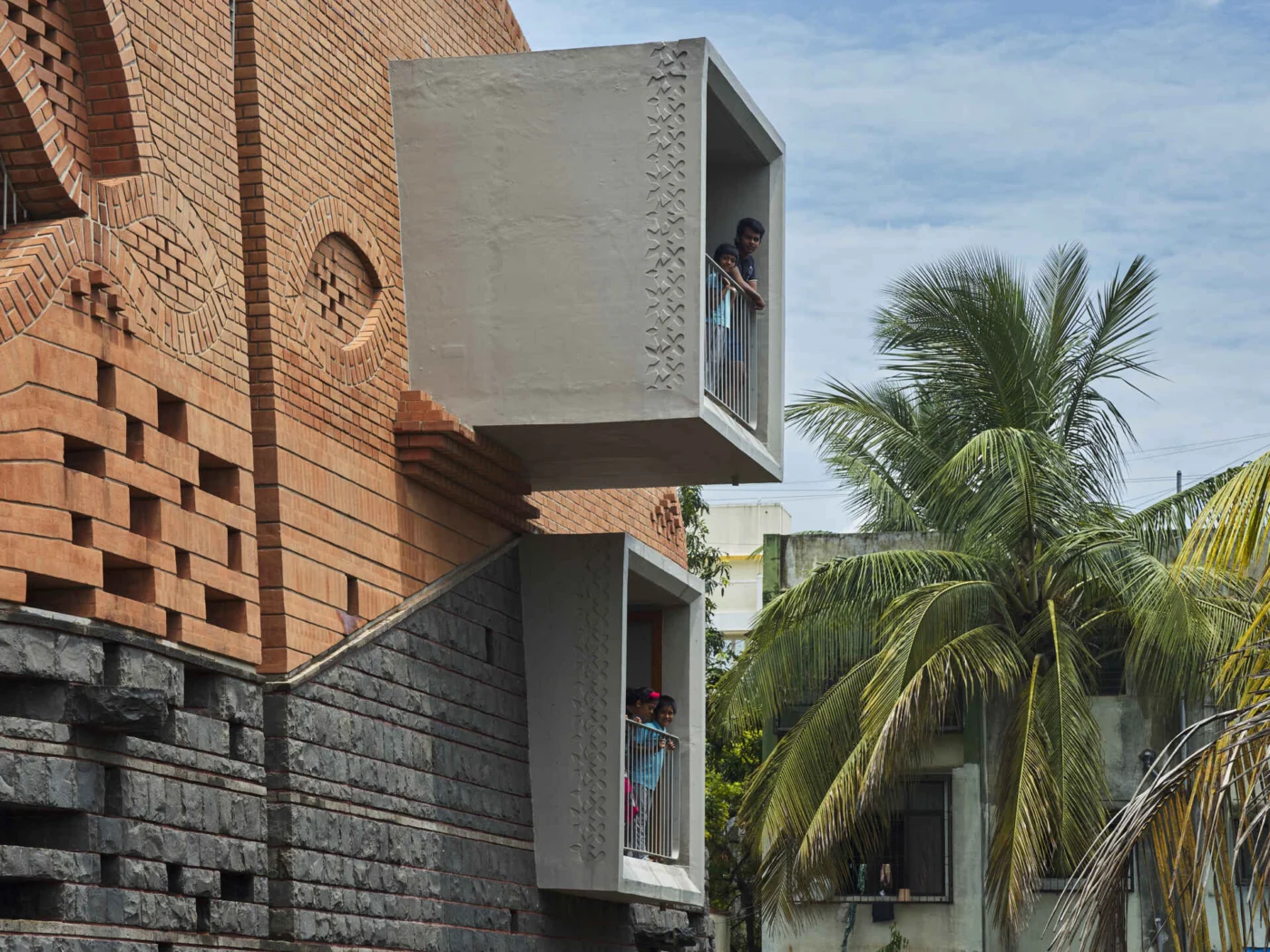 Projecting window boxes set into the brick and stone walls